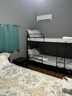 a room with bunk beds and a bed with a bed gmaxwell gmaxwell gmaxwell at Rancho Agua Fria casa in Usulután