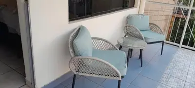 three chairs and a table on a porch at Isabela´s Quality Accommodation in San Salvador