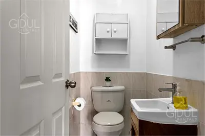 a small bathroom with a toilet and a sink at Comfy & Cozy Apartment in Col Escalon in San Salvador