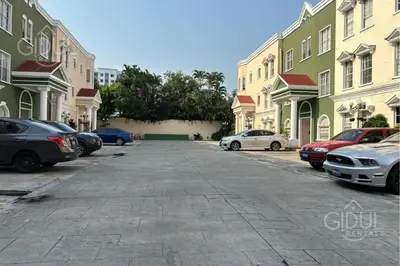 a street with cars parked in front of buildings at Comfy & Cozy Apartment in Col Escalon in San Salvador
