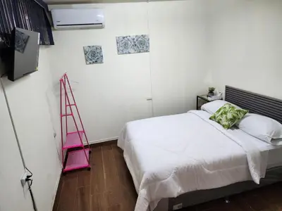 a bedroom with a white bed and a pink ladder at Gywel in San Salvador