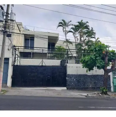 a building with a fence and a tree in front of it at GYWEL 1214 in San Salvador