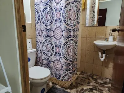 a bathroom with a toilet and a sink at GYWEL1214 3 in San Salvador