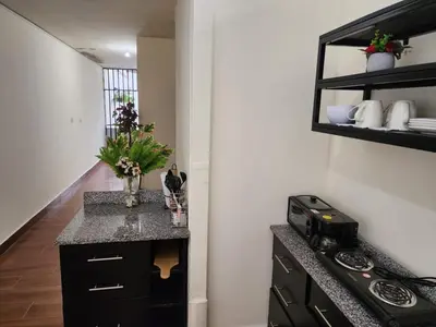 a kitchen with a counter top and a stove at GYWEL1214 3 in San Salvador