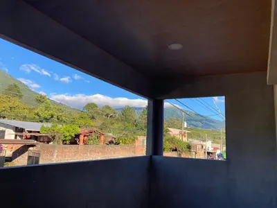 a window in a room with a view of a mountain at Vacacional Abril in Juayúa