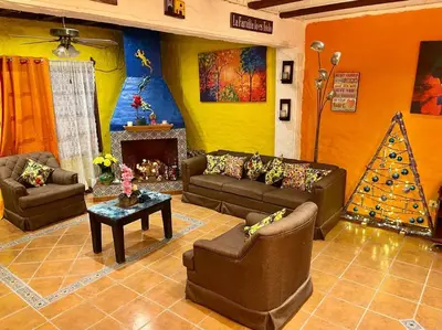 a living room with couches and a christmas tree at Casa Villas Suizas I cerca de Laberinto de Albania in Apaneca
