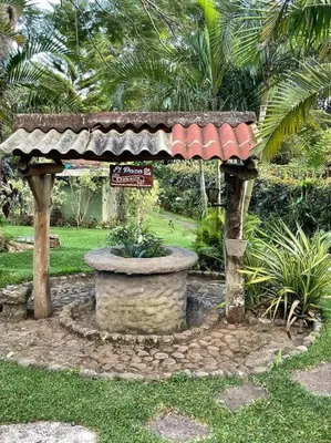 a gazebo with a fountain in a park at Casa Villas Suizas I cerca de Laberinto de Albania in Apaneca
