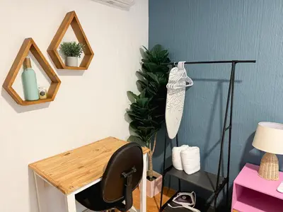a room with a desk with a chair and a lamp at Casa 46 - Escalon in San Salvador