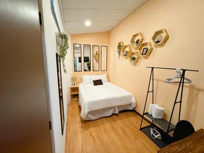 a small room with a bed and a mirror at Casa 46 - Escalon in San Salvador