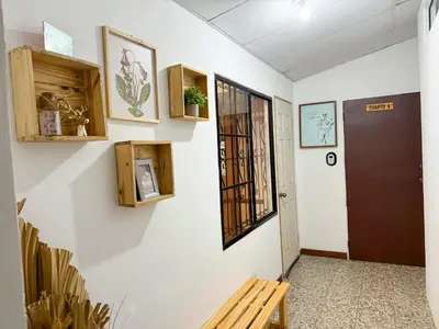 a hallway with a door and a bench at Casa 46 - Escalon in San Salvador