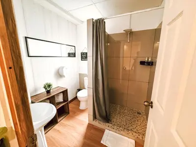 a bathroom with a shower and a toilet and a sink at Casa 46 - Escalon in San Salvador