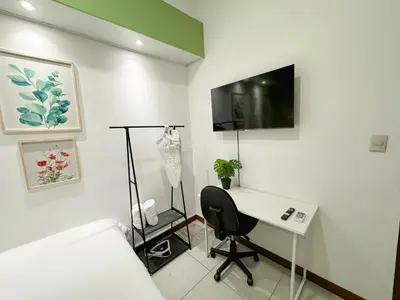 a bedroom with a desk and a bed and a tv at Casa 46 - Escalon in San Salvador