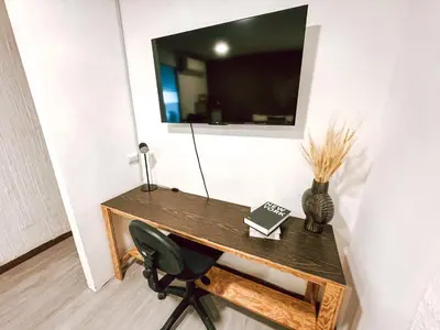 a desk with a chair and a mirror on a wall at Casa 46 - Escalon in San Salvador