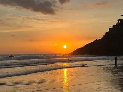 a person standing on the beach at sunset at Shalpabay - Rooms in Taquillo