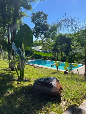 a pool with a plant and a rock in the grass at Shalpabay - Rooms in Taquillo