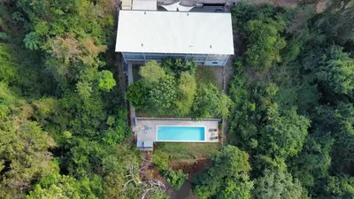 an overhead view of a house with a pool in the forest at Shalpabay House in Taquillo