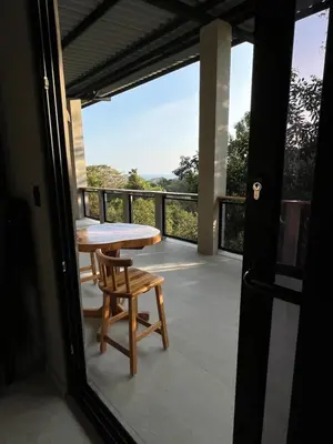 a balcony with a table and a chair and a view at Shalpabay House in Taquillo