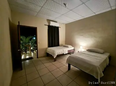 a hotel room with two beds and a window at Equiped cozy Room for rent! in La Libertad