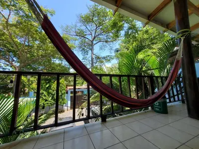a hammock on the balcony of a house at Equiped cozy Room for rent! in La Libertad