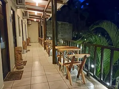 a row of tables and chairs on a balcony at Equiped cozy Room for rent! in La Libertad