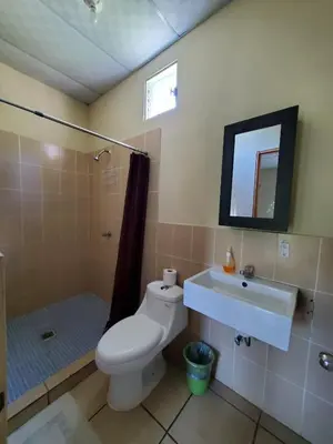 a bathroom with a toilet and a sink and a shower at Equiped cozy Room for rent! in La Libertad