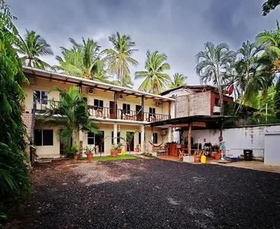 a house with palm trees in front of it at Equiped cozy Room for rent! in La Libertad