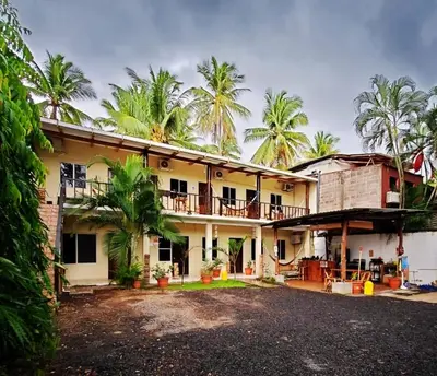 an exterior view of a house with palm trees at Equiped cozy Room for rent! in La Libertad