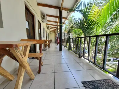a balcony with a wooden table and benches at Equiped cozy Room for rent! in La Libertad