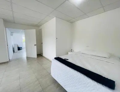 a white bedroom with a large bed in it at Stay Loft Mejicanos A 10 min del Centro Histórico in Mexicanos