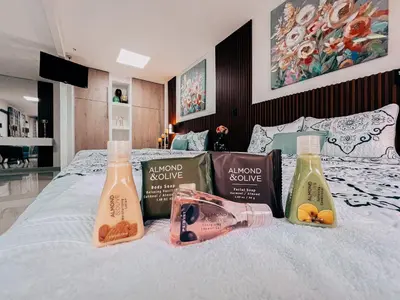 a bed with three bottles of detergents on it at Hotel San Angelo in Concepción de Ataco