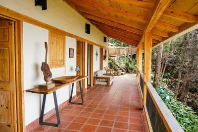 a porch of a house with a wooden ceiling at Cabaña en las Montañas de El Trifinio in Metapán