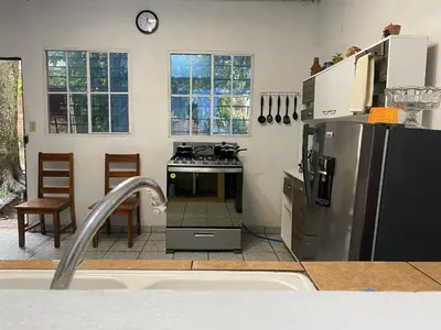 a kitchen with a stove and a refrigerator at Casa Juayúa in Juayúa