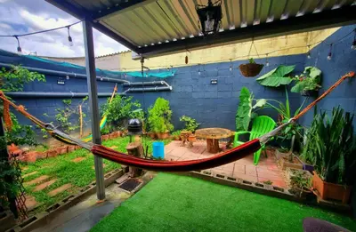 a hammock in a garden with a patio at Las Palmeritas in Ahuachapán