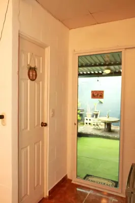 a door to a patio with a view of a yard at Las Palmeritas in Ahuachapán