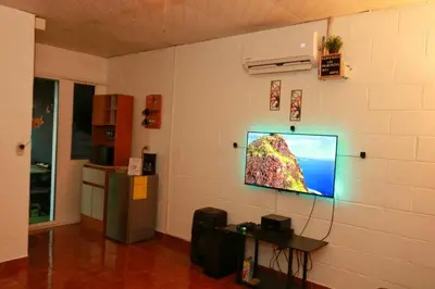 a room with a tv on a wall at Las Palmeritas in Ahuachapán