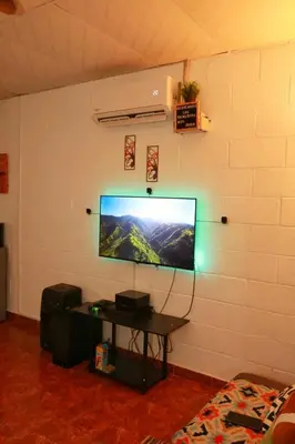 a flat screen tv hanging on a wall at Las Palmeritas in Ahuachapán