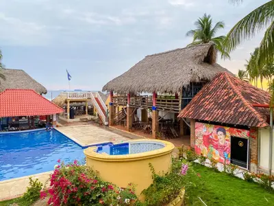a resort with a swimming pool and a building at Hotel y Restaurante Punta Diamantes in Acajutla