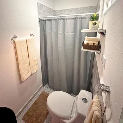 a bathroom with a toilet and a shower at Casa Málaga en San Miguel, El Salvador in San Miguel