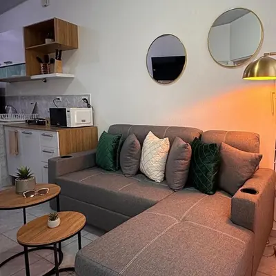 a living room with a couch and two tables at Casa Málaga en San Miguel, El Salvador in San Miguel