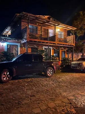 a truck parked in front of a house at night at San Fernando in Concepción de Ataco