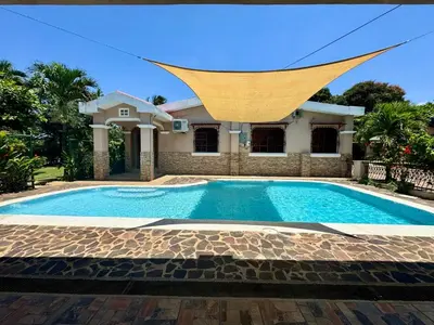 a swimming pool in front of a house at Home with Swimming pool, Wi-FI in Ahuachapán