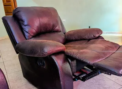 a brown leather reclining chair in a living room at Home with Swimming pool, Wi-FI in Ahuachapán