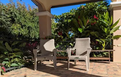 two wicker chairs sitting on a patio at Home with Swimming pool, Wi-FI in Ahuachapán