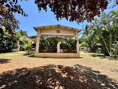a small house with a lot of plants in it at Home with Swimming pool, Wi-FI in Ahuachapán