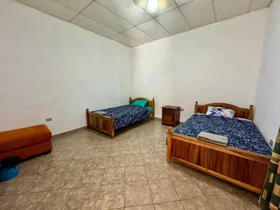 a room with two beds in a room at Home with Swimming pool, Wi-FI in Ahuachapán