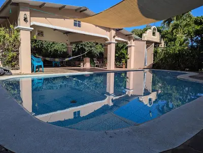 a house with a swimming pool in front of a house at Home with Swimming pool, Wi-FI in Ahuachapán