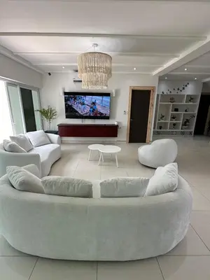 a living room with two couches and a tv at Mariposa Reina A in El Tamarindo