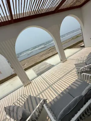 a balcony with chairs and a view of the beach at Mariposa Reina A in El Tamarindo