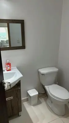 a bathroom with a white toilet and a sink at Mariposa Reina A in El Tamarindo