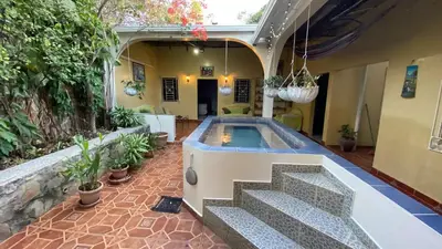 a swimming pool in the middle of a house at Chalchuapa’s Haven in Chalchuapa
